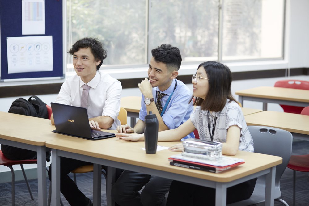 three students laugh in lesson